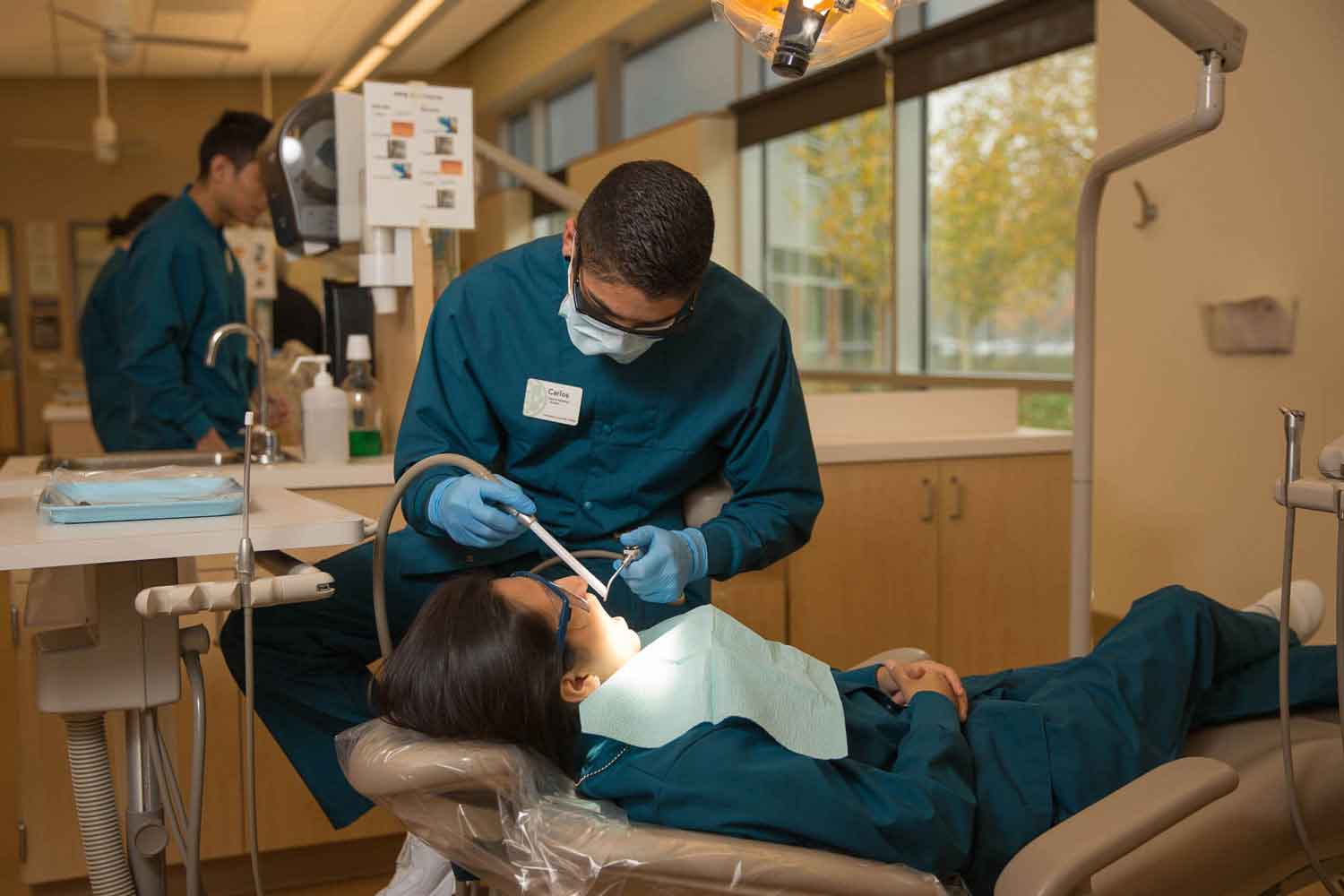 Dental assisting student performing an examination.